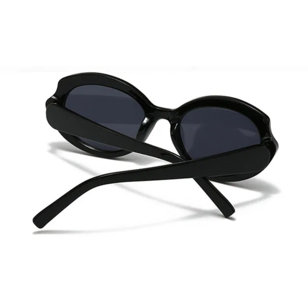Amoura oversized round women's shades in black acetate frame with black polycarbonate lenses, 100% UV protection, rear view with crossed temples on white background