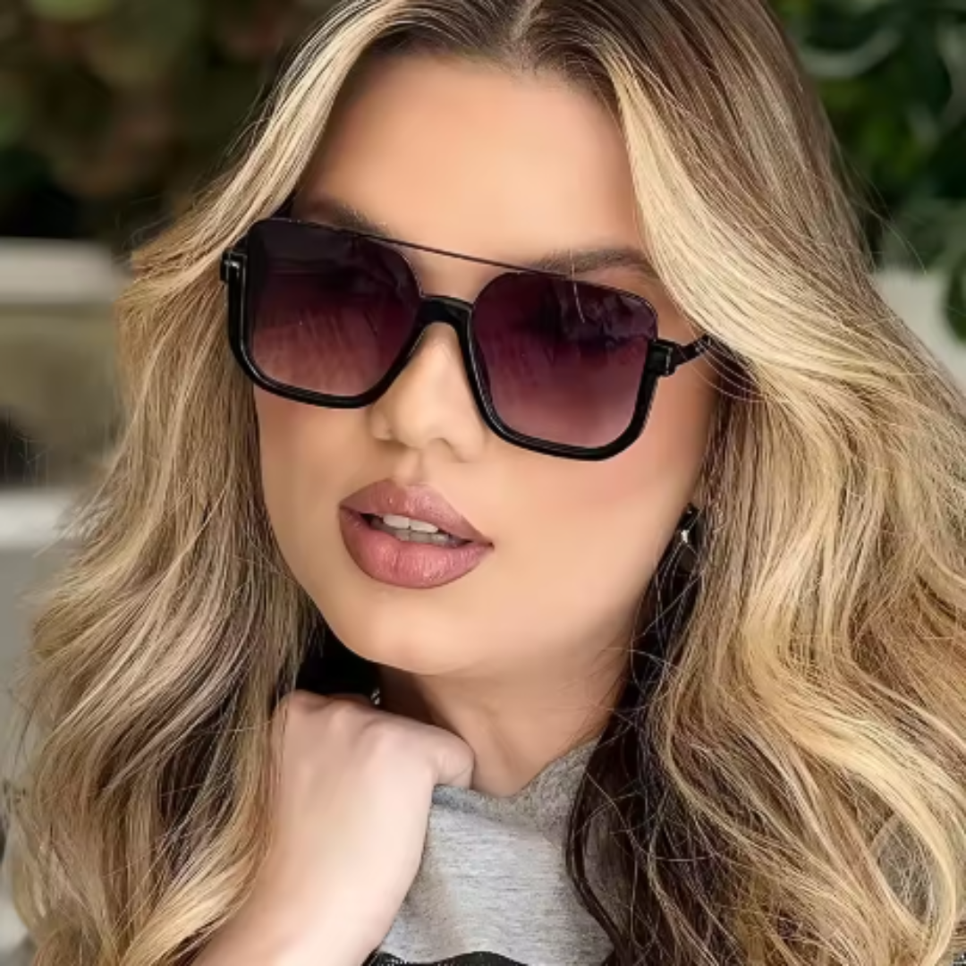 Alt text: Model wearing Opéra women's aviator-inspired square sunglasses, gold lightweight metal frame with purple gradient UV400 resin lenses, facing forward towards the camera with left hand holding the collar of the blouse, outdoor background.