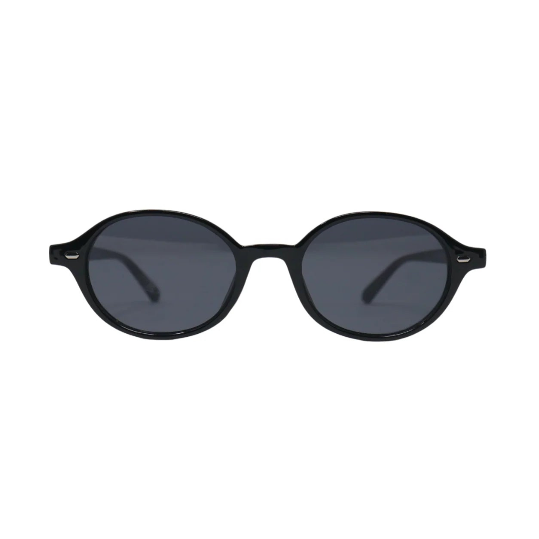 Front view of Lunéra women’s oval sunglasses in Black frame with Black lenses, on white background — polycarbonate frame, 100% UV protection