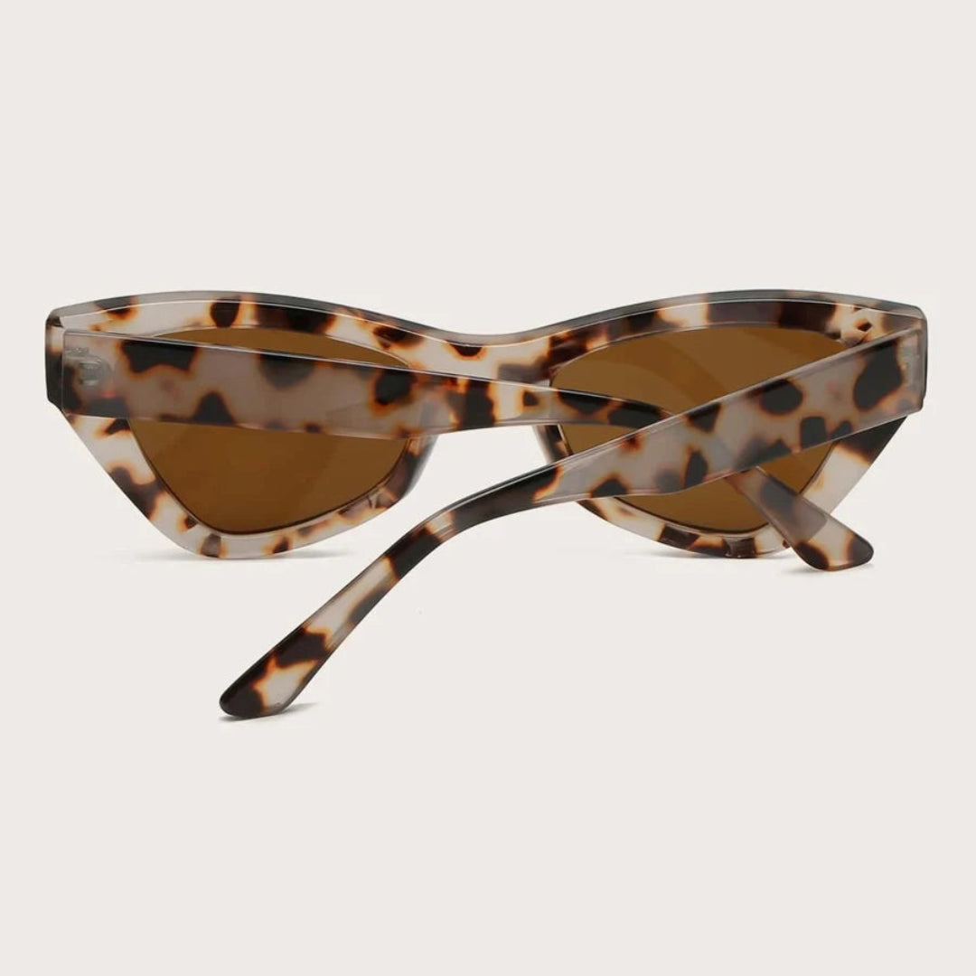 Vibea cat-eye women's sunglasses in Leopard acetate frame with amber TAC lenses, 100% UV protection, rear view with crossed temples on white background