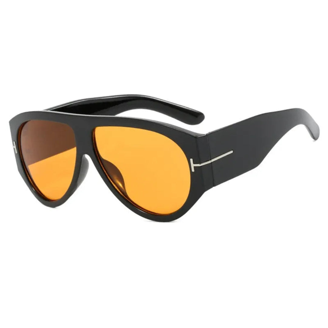 Cannes oversized shield women's sunglasses in black acetate frame with soft orange TAC lenses, 100% UV protection, right 3/4 angle view on white background