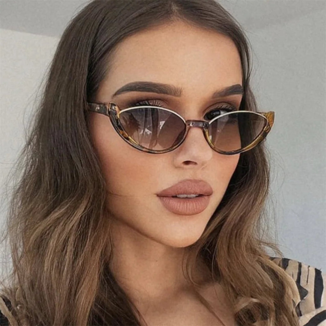 Model wearing Venice women's cat-eye shades, tortoise premium acetate frame with brown gradient TAC lenses offering UV400 protection, face slightly turned to the right looking at the camera, white wall background.