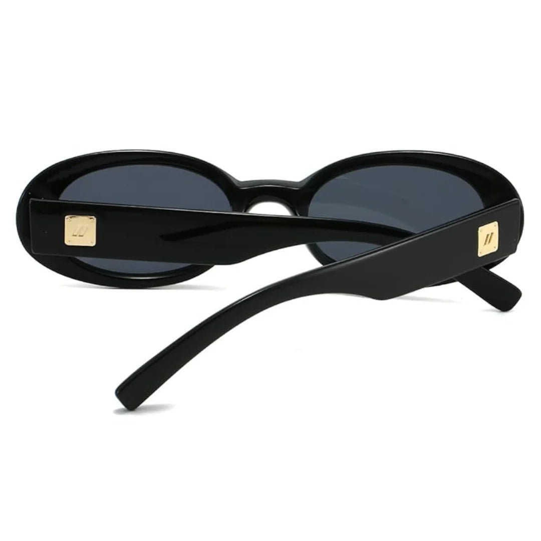 Rear view of Vienna women’s oval sunglasses in Black frame with Black lenses, temples crossed, on white background — acetate frame, polycarbonate lenses, 100% UV protection