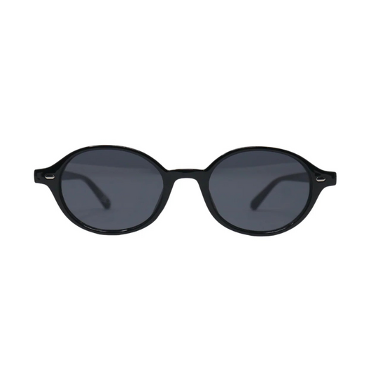 Front view of Lunéra women’s oval sunglasses in Black frame with Black lenses, on white background — polycarbonate frame, 100% UV protection